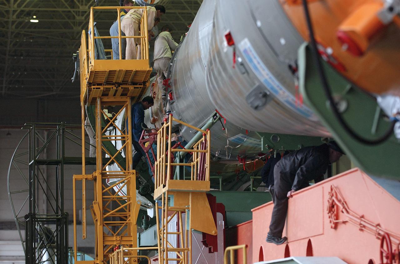 Engineers at the Baikonur Cosmodrome mated the Soyuz TMA-4 capsule with its booster rocket in preparation for a launch on April 19 of the Expedition 9 crew and a European astronaut to the International Space Station, Friday, April 16, 2004 in Baikonur, Kazakhstan. Photo Credit: (NASA/Bill Ingalls)