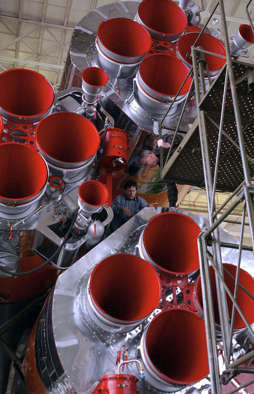 Engineers at the Baikonur Cosmodrome In Kazakhstan work on the aft end of the booster rocket after mating it with the Soyuz TMA-4 capsule in preparation for a launch on April 19 of the Expedition 9 crew and a European astronaut to the International Space Station, Friday, April 16, 2004 in Baikonur, Kazakhstan.  Photo Credit: (NASA/Bill Ingalls)