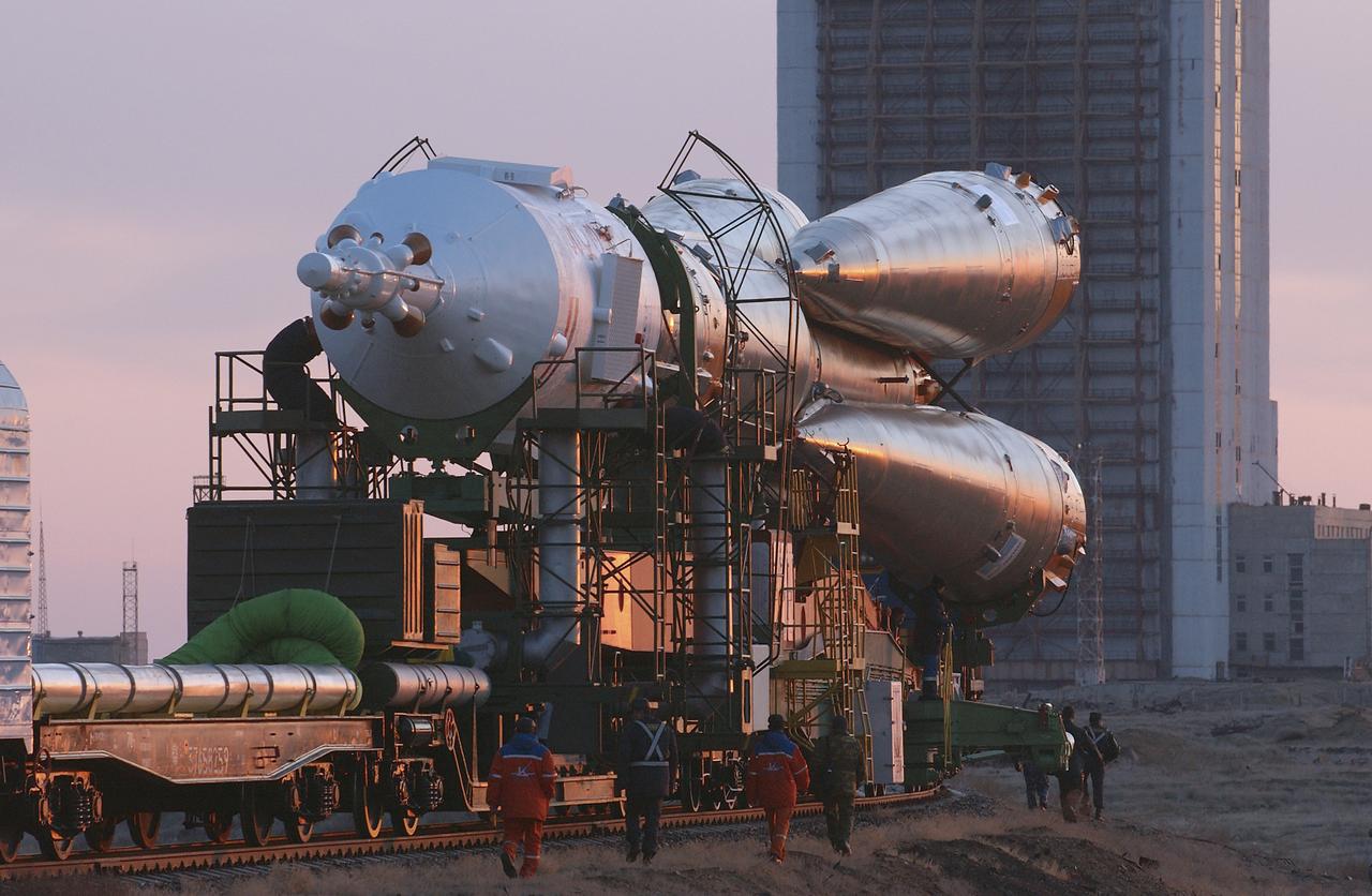 The Soyuz TMA-4 capsule and its booster rocket begin to roll to the launch pad at the Baikonur Cosmodrome on Saturday, April 17, 2004, in Baikonur, Kazakhstan in preparation for the launch of the Expedition 9 crew and a European researcher to the International Space Station on April 19. The Soyuz vehicle is transported to the launch pad horizontally on a railcar from its processing hangar in a process that takes about 2.5 hours to complete. Photo Credit: (NASA/Bill Ingalls)