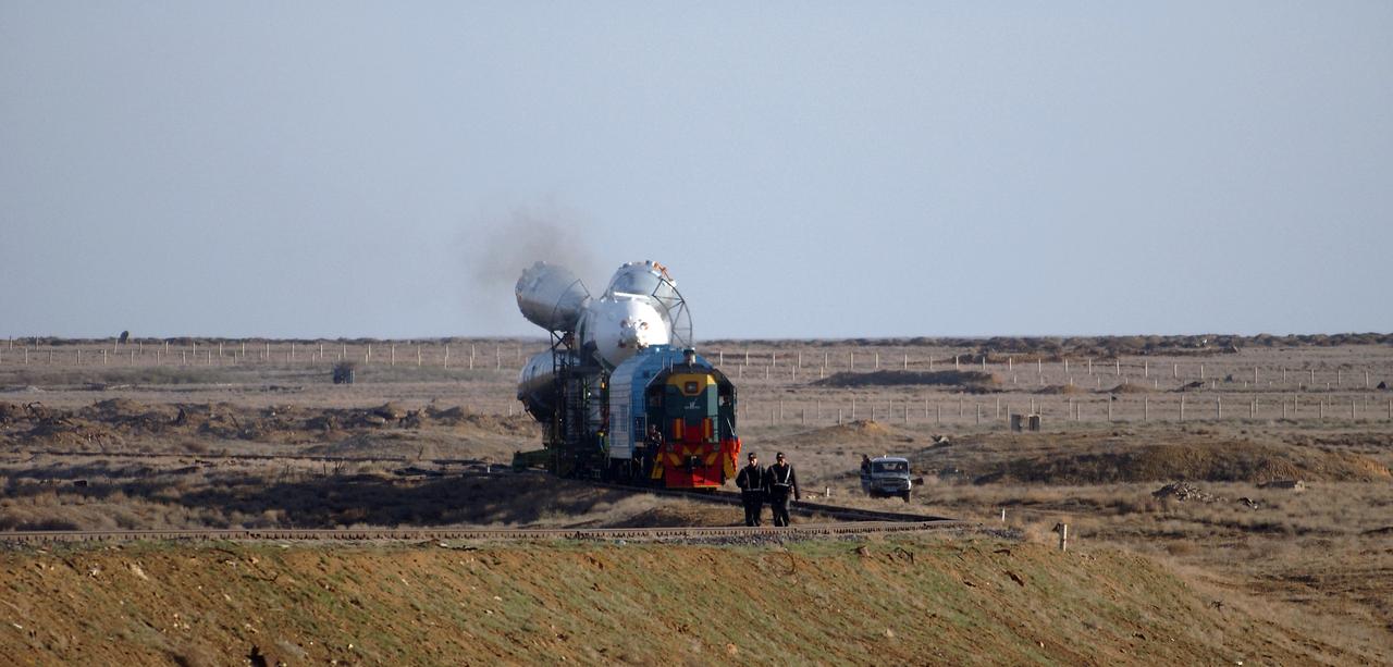 The Soyuz TMA-4 capsule and its booster rocket begin to roll to the launch pad at the Baikonur Cosmodrome on Saturday, April 17, 2004, in Baikonur, Kazakhstan in preparation for the launch of the Expedition 9 crew and a European researcher to the International Space Station on April 19. The Soyuz vehicle is transported to the launch pad horizontally on a railcar from its processing hangar in a process that takes about 2.5 hours to complete. Photo Credit: (NASA/Bill Ingalls)