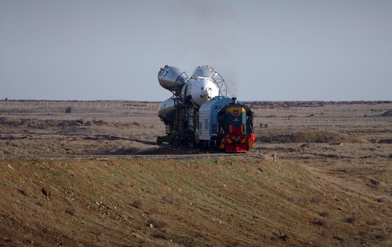 The Soyuz TMA-4 capsule and its booster rocket begin to roll to the launch pad at the Baikonur Cosmodrome on Saturday, April 17, 2004, in Baikonur, Kazakhstan in preparation for the launch of the Expedition 9 crew and a European researcher to the International Space Station on April 19. The Soyuz vehicle is transported to the launch pad horizontally on a railcar from its processing hangar in a process that takes about 2.5 hours to complete. Photo Credit: (NASA/Bill Ingalls)