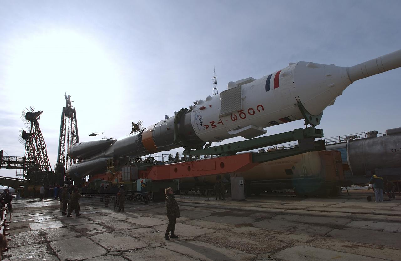 The Soyuz TMA-4 capsule and its booster rocket are raised into position at the launch pad at the Baikonur Cosmodrome on Saturday, April 17, 2004, in Baikonur, Kazakhstan in preparation for the launch of the Expedition 9 crew and a European researcher to the International Space Station on April 19. The Soyuz vehicle is transported to the launch pad horizontally on a railcar from its processing hangar in a process that takes about 2.5 hours to complete. Photo Credit: (NASA/Bill Ingalls)