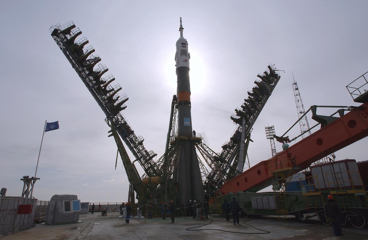 The Soyuz TMA-4 capsule and its booster rocket are raised into position at the launch pad at the Baikonur Cosmodrome on Saturday, April 17, 2004, in Baikonur, Kazakhstan in preparation for the launch of the Expedition 9 crew and a European researcher to the International Space Station on April 19. The Soyuz vehicle is transported to the launch pad horizontally on a railcar from its processing hangar in a process that takes about 2.5 hours to complete. Photo Credit: (NASA/Bill Ingalls)