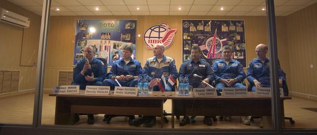 Starting from left, Flight Engineer and NASA Science Officer Mike Fincke, Expedition 9 Commander Gennady Padalka, European Space Agency astronaut Andre Kuipers of the Netherlands, NASA Expedition 9 backup Commander Leroy Chiao, backup Flight Engineer Salizhan Sharipov and backup European Space Agency astronaut Gerhard Thiele of Germany, talk to reporterrs from behind glass during a press conference held at the Cosmonaut Hotel, Sunday, April 18, 2004, in Baikonur, Kazakhstan. Expedition 9 is scheduled to be launched on April 19, to the International Space Station for an arrival on April 21. Photo Credit: (NASA/Bill Ingalls)