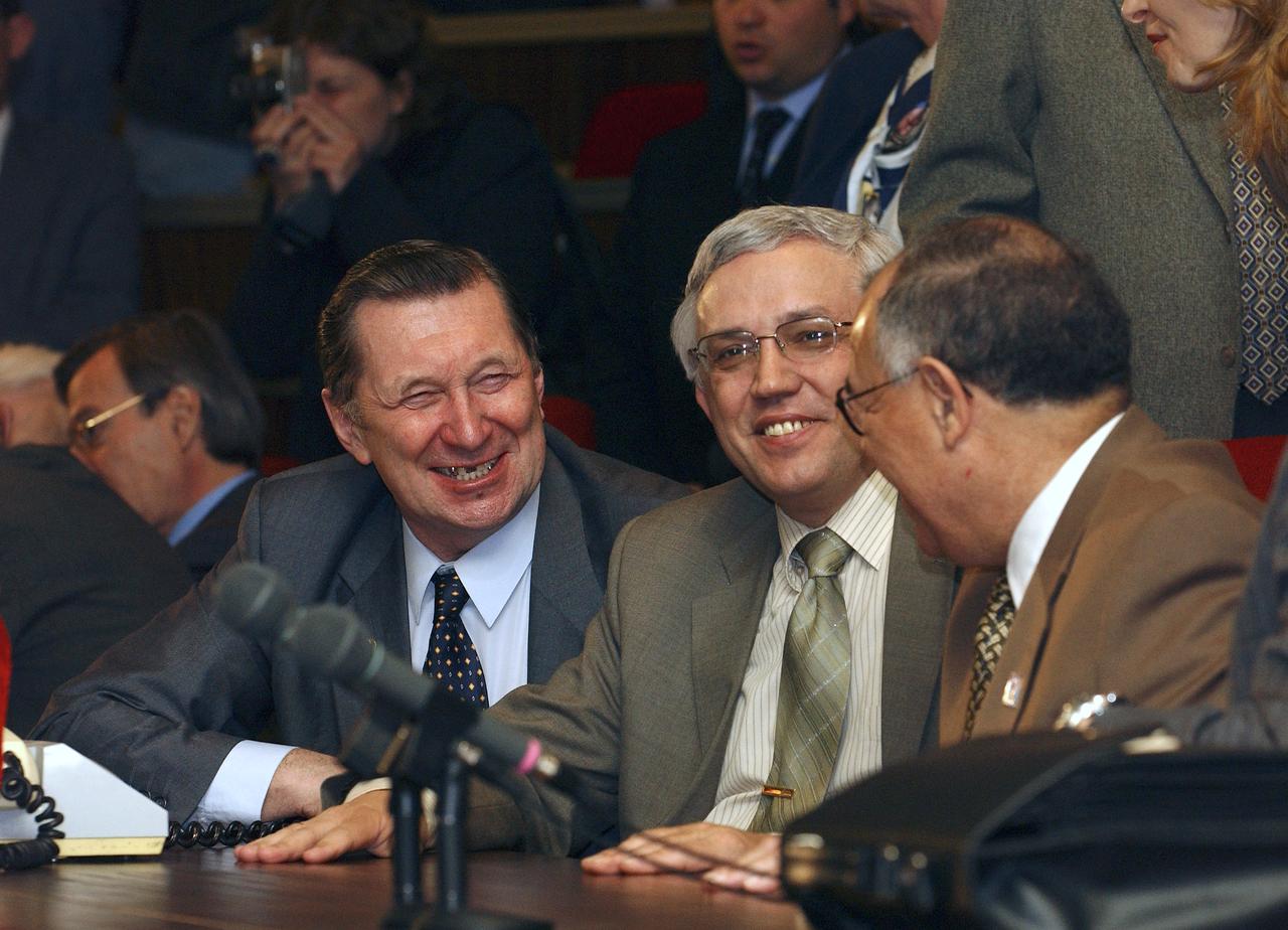 NASA Deputy Administrator Fred Gregory, right, and Nikolai Moiseev, Deputy General-Director of the Russian Federal Space Agency, center, share a light-hearted moment at the Russian Mission Control Center outside Moscow, Wednesday, April 21, 2004, following the successful docking of a Russian Soyuz spacecraft to the International Space Station. The Soyuz brought the new Expedition 9 crew and a European Space Agency researcher to the Station following their launch from the Baikonur Cosmodrome in Kazakhstan.  Photo Credit: (NASA/Bill Ingalls)