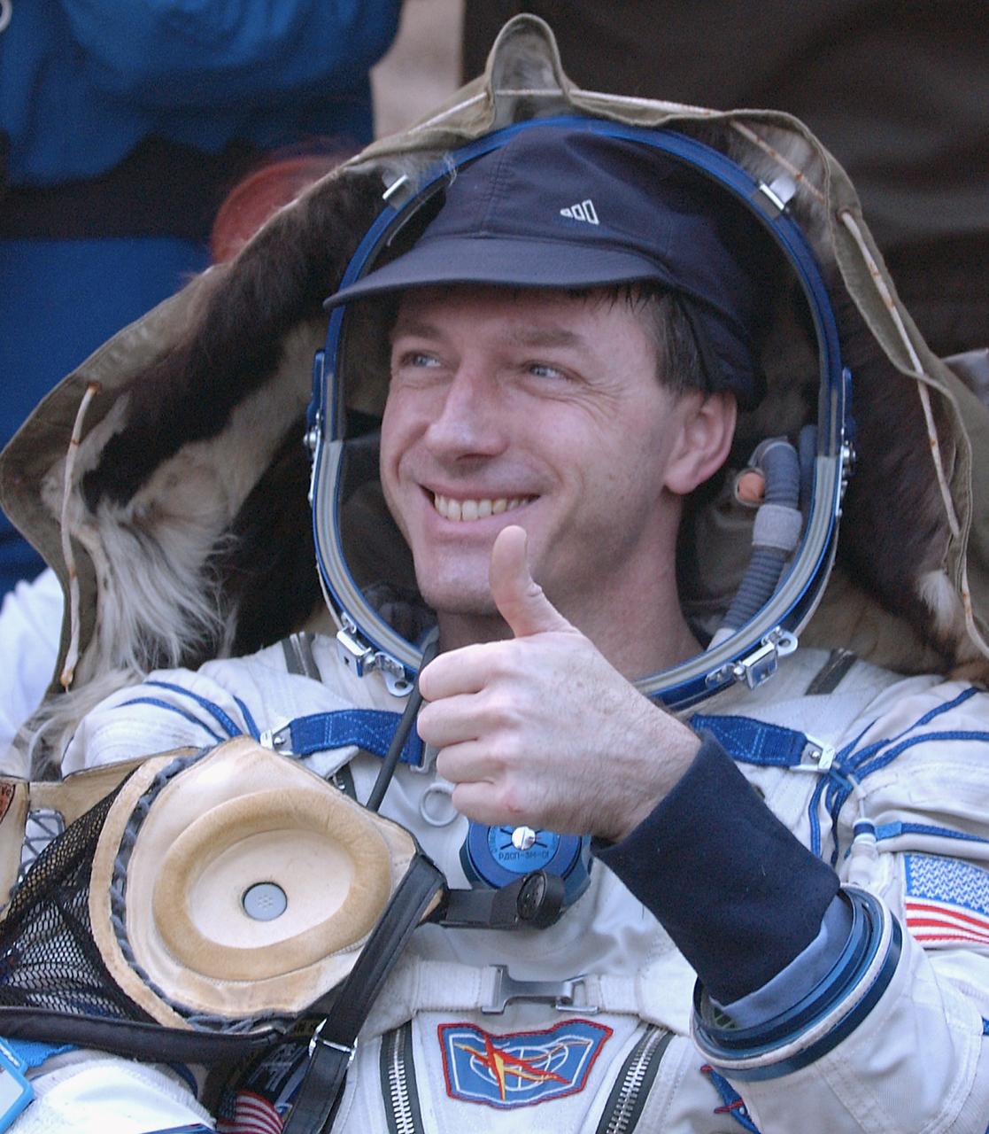 Expedition 8 Commander Michael Foale gives a thumbs up after he and his crew mates, Soyuz Flight Engineer Alexander Kaleri and European Space Agency astronaut Andre Kuipers, of the Netherlands, touched down in north central Kazakhstan, Friday, April 30, 2004, in their Soyuz TMA-3 capsule. Foale and Kaleri completed 195 days in space aboard the International Space Station, while Kuipers returned after an 11-day research mission as part of a commercial agreement between ESA and the Russian Federal Space Agency. Photo Credit (NASA/Bill Ingalls)   