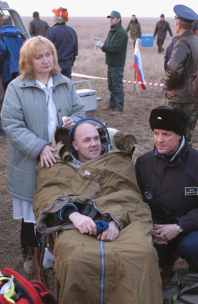 European Space Agency astronaut Andre Kuipers, of the Netherlands, is checked by his flight surgeon after he and Expedition 8 Commander Michael Foale and Soyuz Flight Engineer Alexander Kaleri landed in north central Kazakhstan, Friday, April 30, 2004, in their Soyuz TMA-3 capsule. Foale and Kaleri completed 195 days in space aboard the International Space Station, while Kuipers returned after an 11-day research mission as part of a commercial agreement between ESA and the Russian Federal Space Agency. Photo Credit: (NASA/Bill Ingalls)