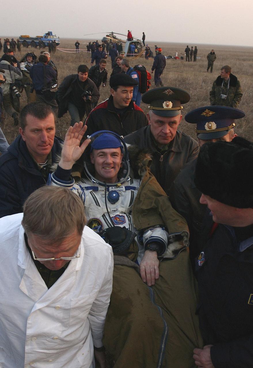 European Space Agency astronaut Andre Kuipers, of the Netherlands, is carried in a chair from the Soyuz landing site to an inflatable medical tent after he and Expedition 8 Commander Michael Foale and Soyuz Flight Engineer Alexander Kaleri landed in north central Kazakhstan, Friday, April 30, 2004, in a Soyuz TMA-3 capsule. Foale and Kaleri completed 195 days in space aboard the International Space Station, while Kuipers returned after an 11-day research mission as part of a commercial agreement between ESA and the Russian Federal Space Agency. Photo Credit: (NASA/Bill Ingalls)