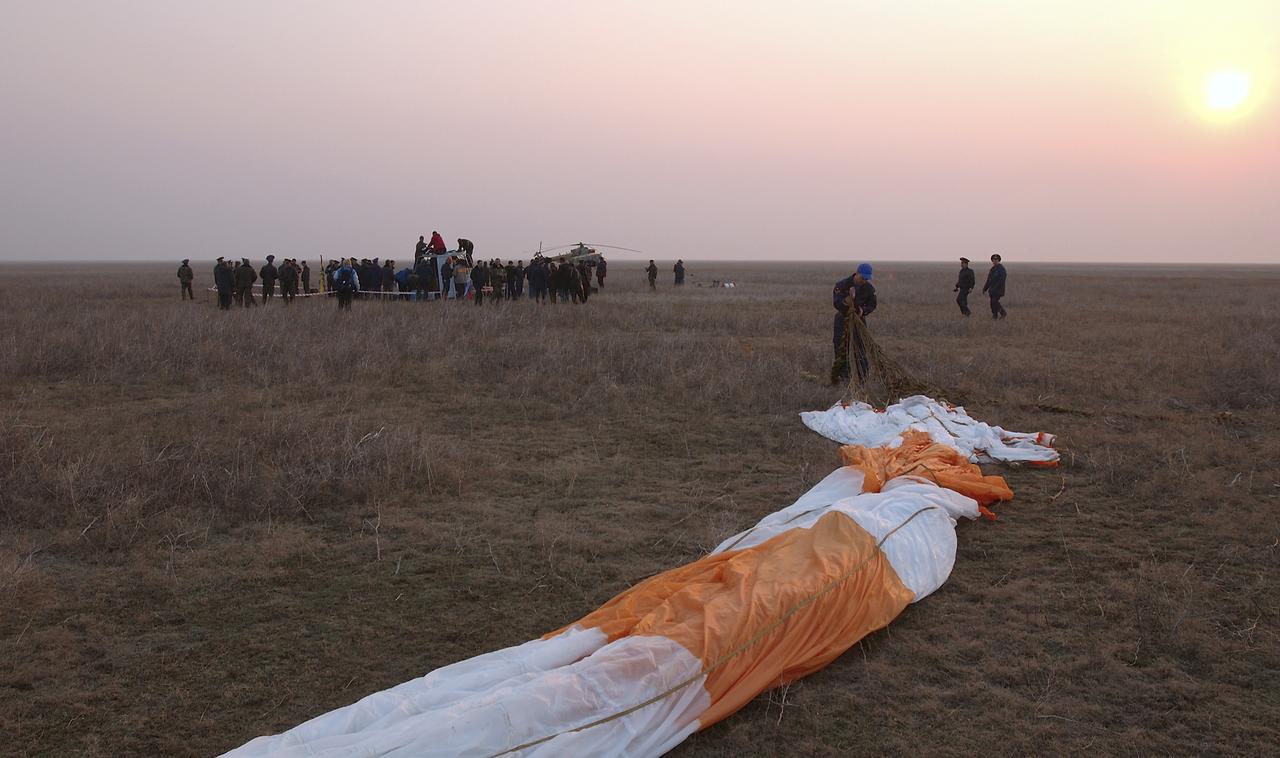 The main chute for the Soyuz capsule is prepared for folding, Friday, April 30, 2004, following the landing of the Expedition 8. Commander Michael Foale, Soyuz Flight Engineer Alexander Kaleri and European Space Agency astronaut Andre Kuipers of the Netherlands landed in north central Kazakhstan in a Soyuz TMA-3 capsule. Foale and Kaleri completed 195 days in space aboard the International Space Station, while Kuipers returned after an 11-day research mission as part of a commercial agreement between ESA and the Russian Federal Space Agency. Photo Credit: (NASA/Bill Ingalls)