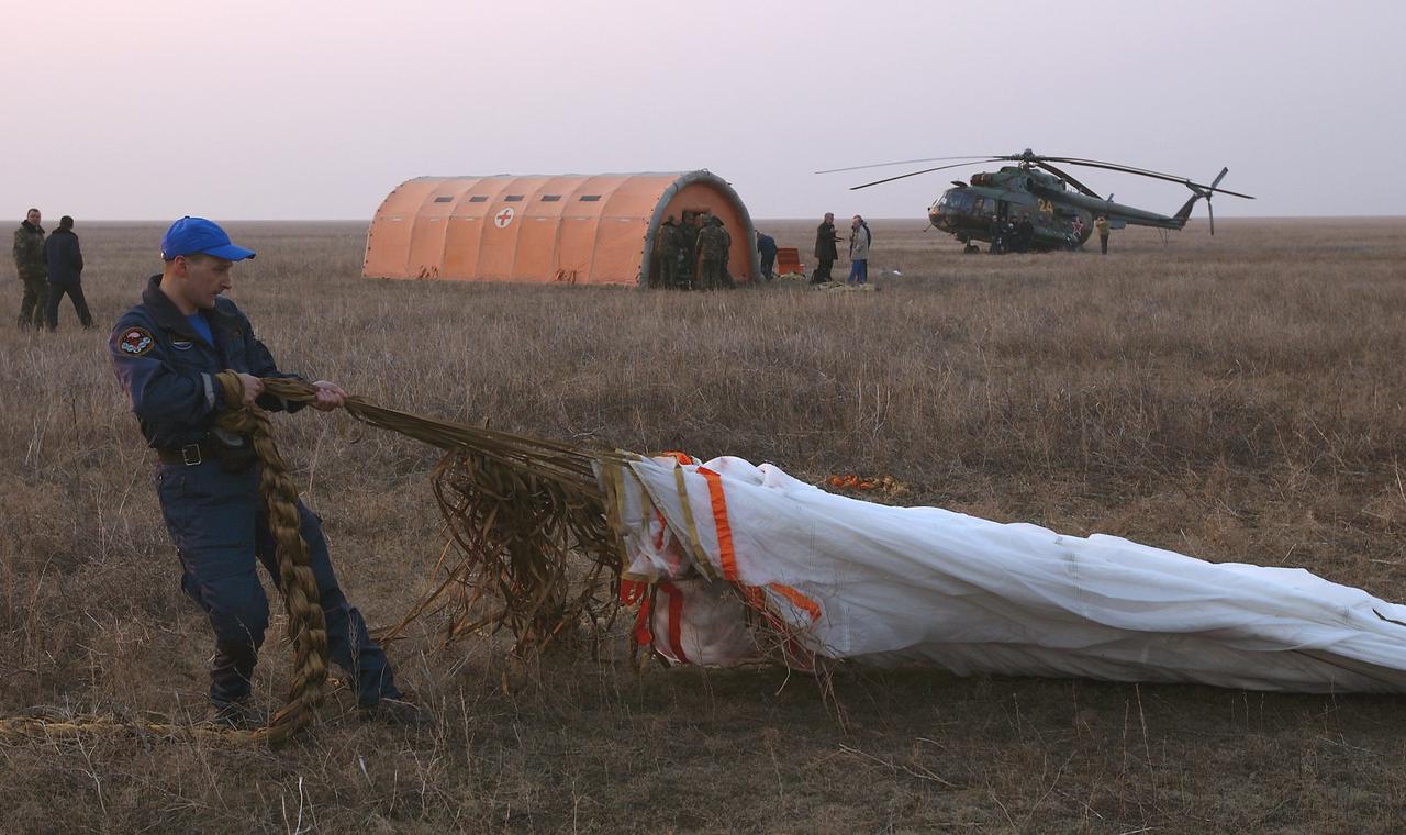 The main parachute for the Soyuz capsule is prepared for folding, Friday, April 30, 2004, following the landing of the Expedition 8. Commander Michael Foale, Soyuz Flight Engineer Alexander Kaleri and European Space Agency astronaut Andre Kuipers of the Netherlands landed in north central Kazakhstan in a Soyuz TMA-3 capsule. Foale and Kaleri completed 195 days in space aboard the International Space Station, while Kuipers returned after an 11-day research mission as part of a commercial agreement between ESA and the Russian Federal Space Agency. Photo Credit: (NASA/Bill Ingalls)