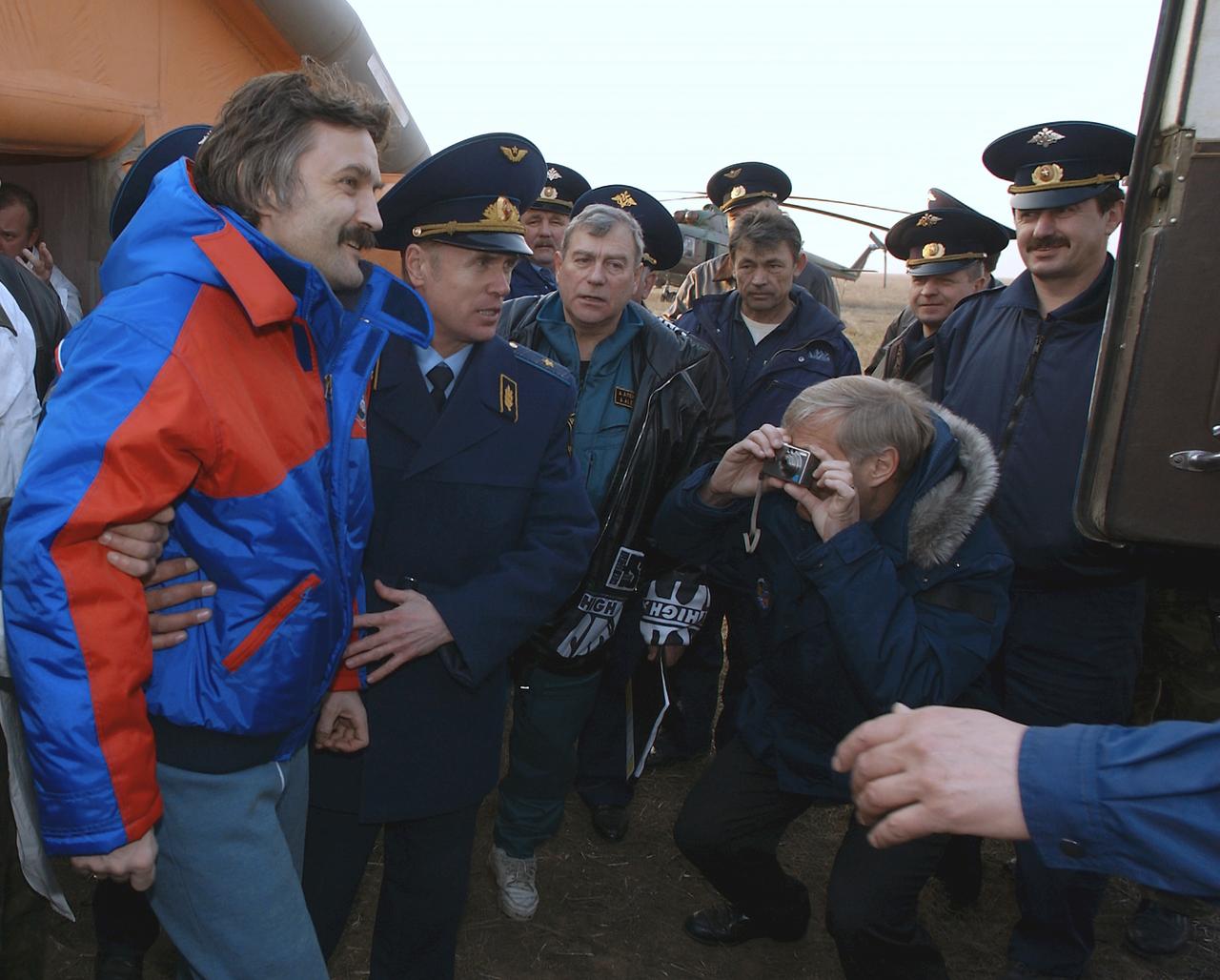Soyuz Flight Engineer Alexander Kaleri is helped from the medical tent to the all terrain vehicle for transportation to a waiting helicopter for the flight to Kustanai, Kazakhstan, Friday, April 30, 2004, after he, Expedition 8 Commander Michael Foale, and European Space Agency astronaut Andre Kuipers of the Netherlands, landed in north central Kazakhstan in a Soyuz TMA-3 capsule. Foale and Kaleri completed 195 days in space aboard the International Space Station, while Kuipers returned after an 11-day research mission as part of a commercial agreement between ESA and the Russian Federal Space Agency. Photo Credit: (NASA/Bill Ingalls)