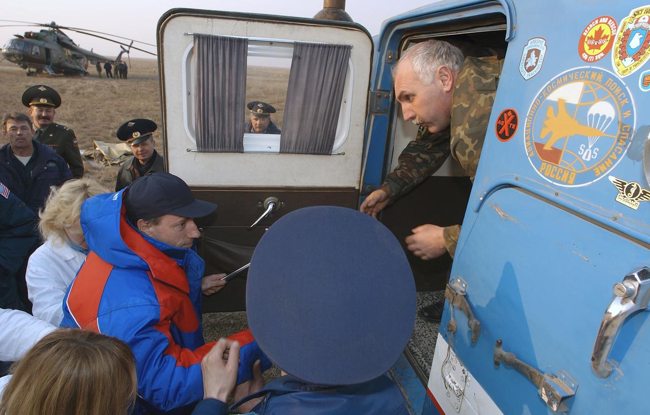 Expedition 8 Commander Michael Foale is helped from the medical tent to an all terrain vehicle for transportation to a helicopter for the flight to Kustanai, Kazakhstan after he, Soyuz Flight Engineer Alexander Kaleri and European Space Agency astronaut Andre Kuipers, of the Netherlands, landed in north central Kazakhstan, Friday, April 30, 2004, in a Soyuz TMA-3 capsule. Foale and Kaleri completed 195 days in space aboard the International Space Station, while Kuipers returned after an 11-day research mission as part of a commercial agreement between ESA and the Russian Federal Space Agency. Photo Credit: (NASA/Bill Ingalls)