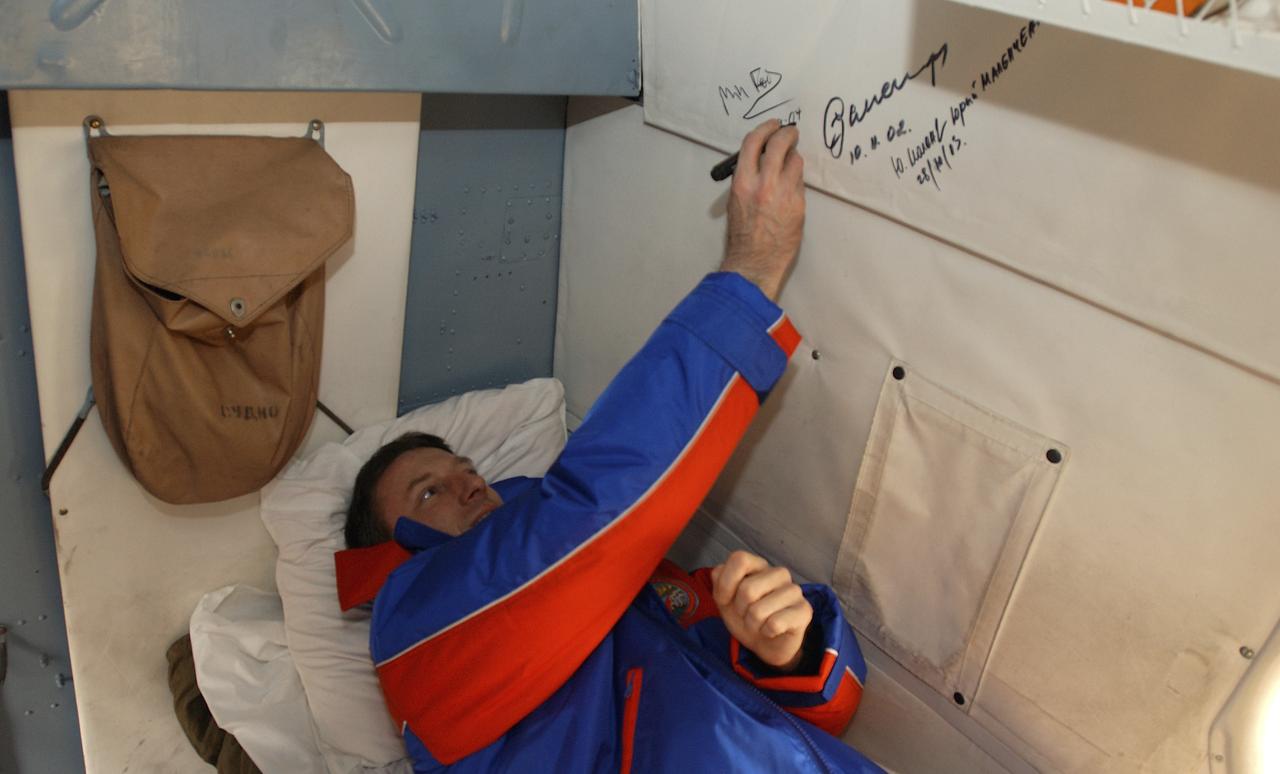 Expedition 8 Commander Michael Foale signs the inside of the Russian search and rescue helicopter as is tradition for returning cosmonauts, after he, Soyuz Flight Engineer Alexander Kaleri and European Space Agency astronaut Andre Kuipers, of the Netherlands, landed in north central Kazakhstan, Friday, April 30, 2004, in a Soyuz TMA-3 capsule. Foale and Kaleri completed 195 days in space aboard the International Space Station, while Kuipers returned after an 11-day research mission as part of a commercial agreement between ESA and the Russian Federal Space Agency. Photo Credit: (NASA/Bill Ingalls)