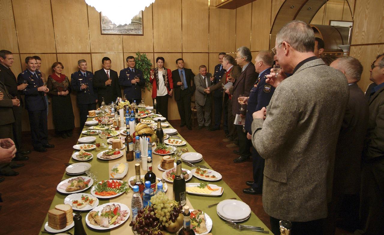 Expedition 10 Commander and NASA Science Officer Leroy Chiao, sixth from left, Flight Engineer and Soyuz Commander Salizhan Sharipov and Russian Space Forces cosmonaut Yuri Shargin, fifth from left, join VIP’s for the crew departure breakfast prior to their departure from Star City, Russia for Baikonur, Kazakhstan, Monday, Oct. 4, 2004.  The Expedition 10 crew will launch on the Soyuz TMA-5 spacecraft October 14, 2004 to the International Space Station.  Photo Credit (NASA/Bill Ingalls)