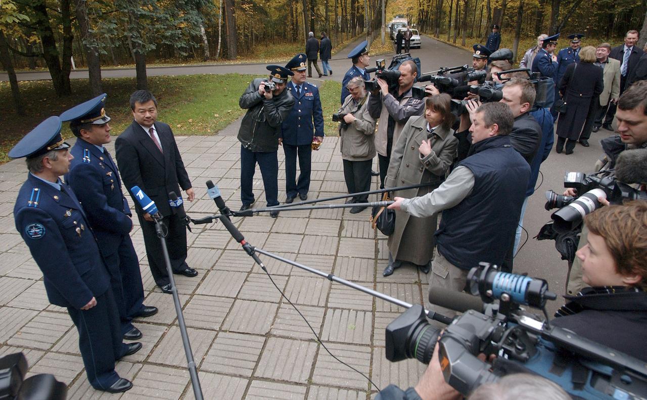 Russian Space Forces cosmonaut Yuri Shargin, Flight Engineer and Soyuz Commander Salizhan Sharipov and Expedition 10 Commander and NASA Science Officer Leroy Chiao, standing left to right, answer questions from the press Monday, Oct. 4, 2004, at Star City, Russia as they prepare for their October 14th launch on the Soyuz TMA-5 spacecraft to the International Space Station. Chiao and Sharipov will spend six months on the Station, while Shargin will return to Earth October 24 with Expedition 9 Commander Gennady Padalka and NASA Science Officer and Flight Engineer Mike Fincke, who have been in space since April.  Photo Credit (NASA/Bill Ingalls) 