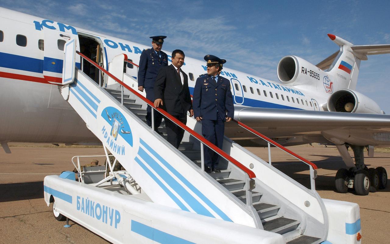 Flight Engineer and Soyuz Commander Salizhan Sharipov, right, Expedition 10 Commander and NASA Science Officer Leroy Chiao and Russian Space Forces cosmonaut Yuri Shargin (behind Sharipov), along with other personnel, depart the plane at Baikonur, Kazakhstan, Monday, Oct. 4, 2004.  The crew will prepare for their launch on the Soyuz TMA-5 spacecraft October 14, 2004 to the International Space Station. Chiao and Sharipov will spend six months on the Station, while Shargin will return to Earth October 24 with Expedition 9 Commander Gennady Padalka and NASA Science Officer and Flight Engineer Mike Fincke, who have been in space since April.  Photo Credit (NASA/Bill Ingalls)