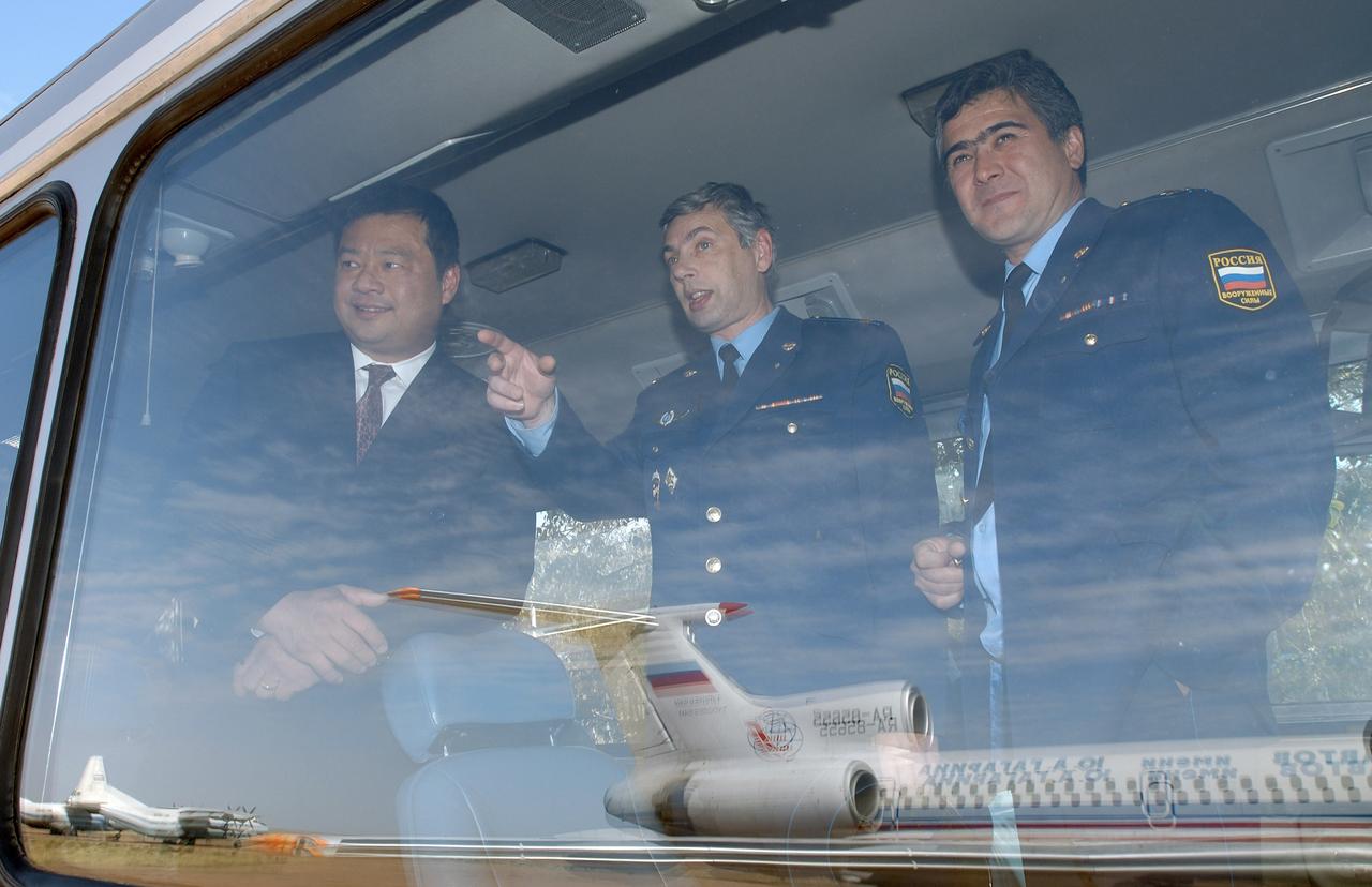 Flight Engineer and Soyuz Commander Salizhan Sharipov, right, Russian Space Forces Cosmonaut Yuri Shargin and Expedition 10 Commander and NASA Science Officer Leroy Chiao, left, look out from the crews' bus at the plane that just delivered them to Baikonur, Kazakhstan from Star City, Russia, Monday, Oct. 4, 2004. The crew will prepare for their launch on the Soyuz TMA-5 spacecraft October 14, 2004 to the International Space Station. Photo Credit (NASA/Bill Ingalls)
