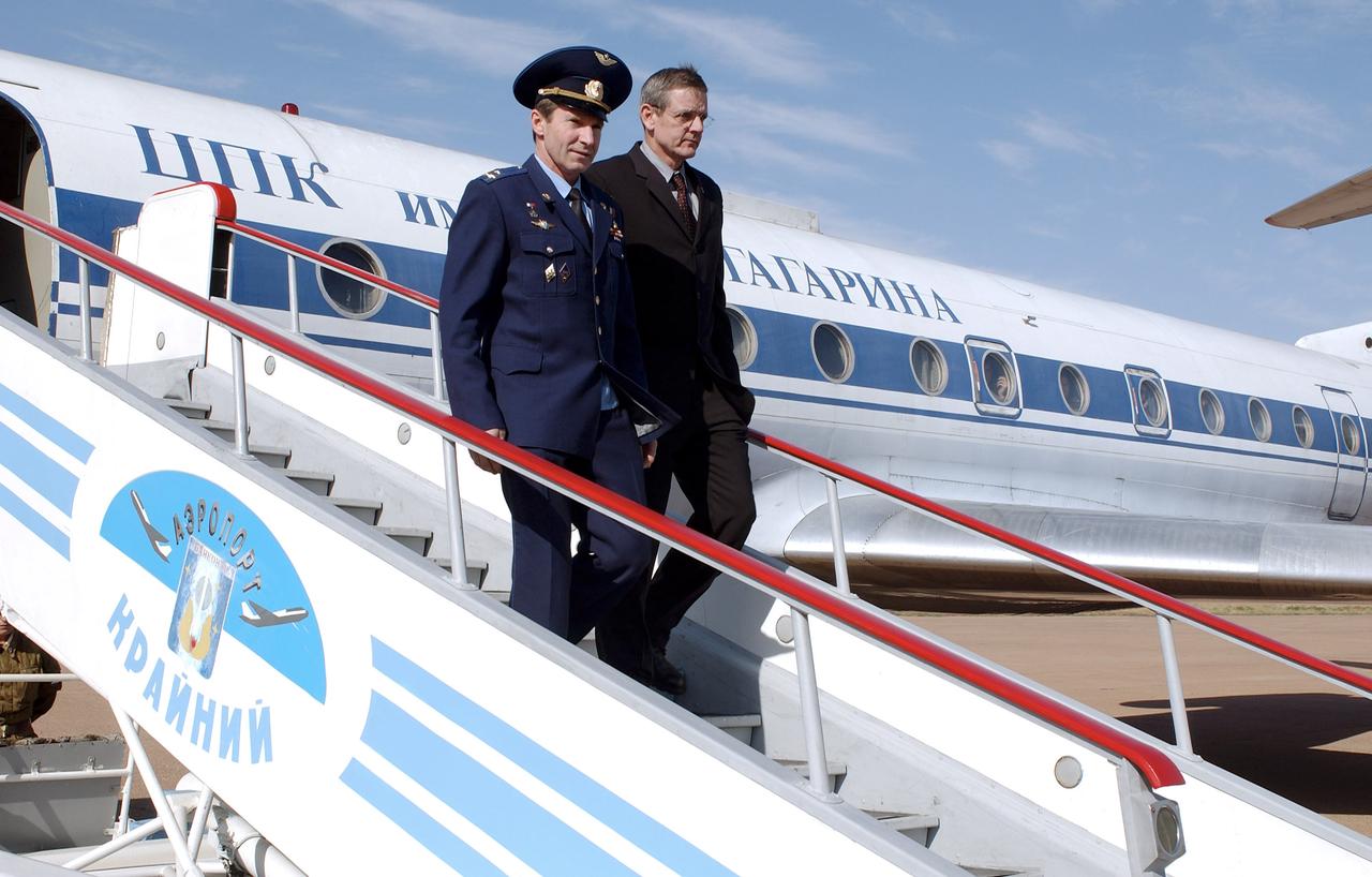 Expedition 10 backup crew members cosmonaut Valery I. Tokarev, left and NASA astronaut William S. McArthur depart the plane at Baikonur, Kazakhstan, Monday, Oct. 4, 2004. The Expedition 10 crew is scheduled to be launched on the Soyuz TMA-5 to the International Space Station on October 14, 2004.  Photo credit: (NASA/Bill Ingalls)   