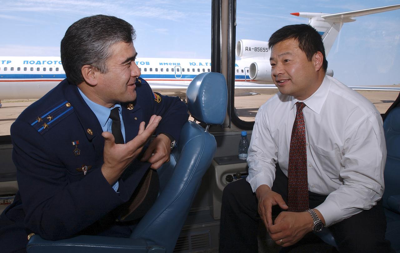 Expedition 10 Commander and NASA Science Officer Leroy Chiao, right and Flight Engineer and Soyuz Commander Salizhan Sharipov talk aboard the crews' bus after their arrival to Baikonur, Kazakhstan from Star City, Russia, Monday, Oct. 4, 2004.  The crew will prepare for their launch on the Soyuz TMA-5 spacecraft October 14, 2004 to the International Space Station. Chiao and Sharipov will spend six months on the Station, while Shargin will return to Earth October 24 with Expedition 9 Commander Gennady Padalka and NASA Science Officer and Flight Engineer Mike Fincke, who have been in space since April.  Photo credit: (NASA/Bill Ingalls)