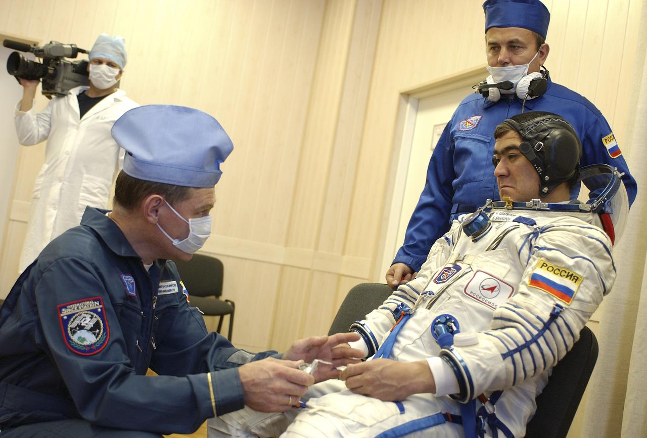 Expedition 10 Flight Engineer and Soyuz Commander Salizhan Sharipov donned his launch and entry suit and climbed aboard the Soyuz TMA-5 spacecraft Friday, October 5, 2004 at the Baikonur Cosmodrome in Kazakhstan for a dress rehearsal of launch day activities leading to their liftoff October 14 to the International Space Station. Chiao and Sharipov, the first crew of all-Asian extraction, will spend six months on the Station.  Shargin will return to Earth October 24 with the Stations' current residents, Expedition 9 Commander Gennady Padalka and NASA Flight Engineer and Science Officer Mike Fincke.  Photo Credit: (NASA/Bill Ingalls)