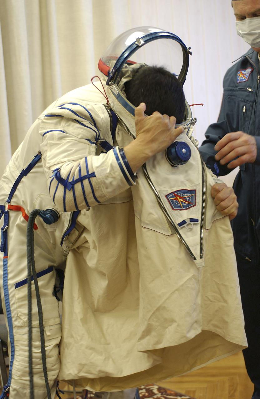 Expedition 10 Commander and NASA Science Officer Leroy Chiao donned his launch and entry suit and climbed aboard the Soyuz TMA-5 spacecraft Friday, October 5, 2004, at the Baikonur Cosmodrome in Kazakhstan for a dress rehearsal of launch day activities leading to their liftoff October 14 to the International Space Station.  Chiao and Sharipov, the first crew of all-Asian extraction, will spend six months on the Station.  Shargin will return to Earth October 24 with the Stations' current residents, Expedition 9 Commander Gennady Padalka and NASA Flight Engineer and Science Officer Mike Fincke.  Photo Credit: (NASA/Bill Ingalls)