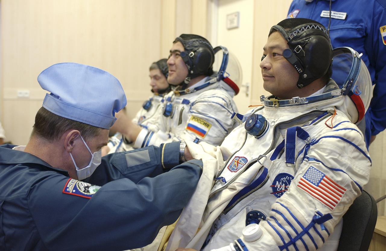 Expedition 10 Commander and NASA Science Officer Leroy Chiao, right, Flight Engineer and Soyuz Commander Salizhan Sharipov and Russian Space Forces cosmonaut Yuri Shargin, left, donned their launch and entry suits and climbed aboard their Soyuz TMA-5 spacecraft Friday, October 5, 2004, at the Baikonur Cosmodrome in Kazakhstan for a dress rehearsal of launch day activities leading to their liftoff October 14 to the International Space Station. Chiao and Sharipov, the first crew of all-Asian extraction, will spend six months on the Station.  Shargin will return to Earth October 24 with the Stations' current residents, Expedition 9 Commander Gennady Padalka and NASA Flight Engineer and Science Officer Mike Fincke.  Photo Credit: (NASA/Bill Ingalls)