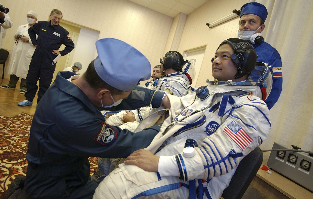 Expedition 10 Commander and NASA Science Officer Leroy Chiao, right, Flight Engineer and Soyuz Commander Salizhan Sharipov and Russian Space Forces cosmonaut Yuri Shargin, left, donned their launch and entry suits and climbed aboard their Soyuz TMA-5 spacecraft Friday, October 5, 2004, at the Baikonur Cosmodrome in Kazakhstan for a dress rehearsal of launch day activities leading to their liftoff October 14 to the International Space Station. Chiao and Sharipov, the first crew of all-Asian extraction, will spend six months on the Station.  Shargin will return to Earth October 24 with the Stations' current residents, Expedition 9 Commander Gennady Padalka and NASA Flight Engineer and Science Officer Mike Fincke.  Photo Credit: (NASA/Bill Ingalls)