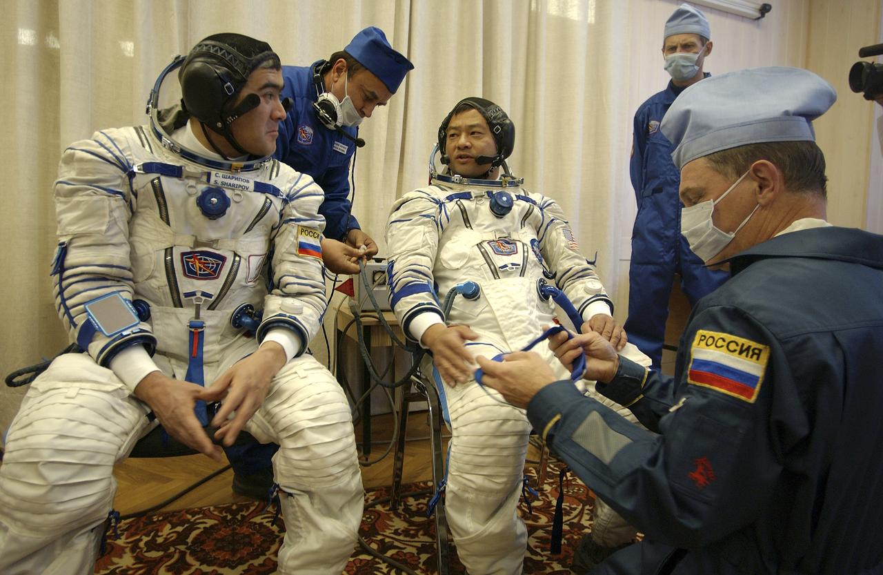 Expedition 10 Commander and NASA Science Officer Leroy Chiao, right, Flight Engineer and Soyuz Commander Salizhan Sharipov donned their launch and entry suits and climbed aboard their Soyuz TMA-5 spacecraft Friday, October 5, 2004, at the Baikonur Cosmodrome in Kazakhstan for a dress rehearsal of launch day activities leading to their liftoff October 14 to the International Space Station.  Chiao and Sharipov, the first crew of all-Asian extraction, will spend six months on the Station.  Shargin will return to Earth October 24 with the Stations' current residents, Expedition 9 Commander Gennady Padalka and NASA Flight Engineer and Science Officer Mike Fincke.  Photo Credit: (NASA/Bill Ingalls)