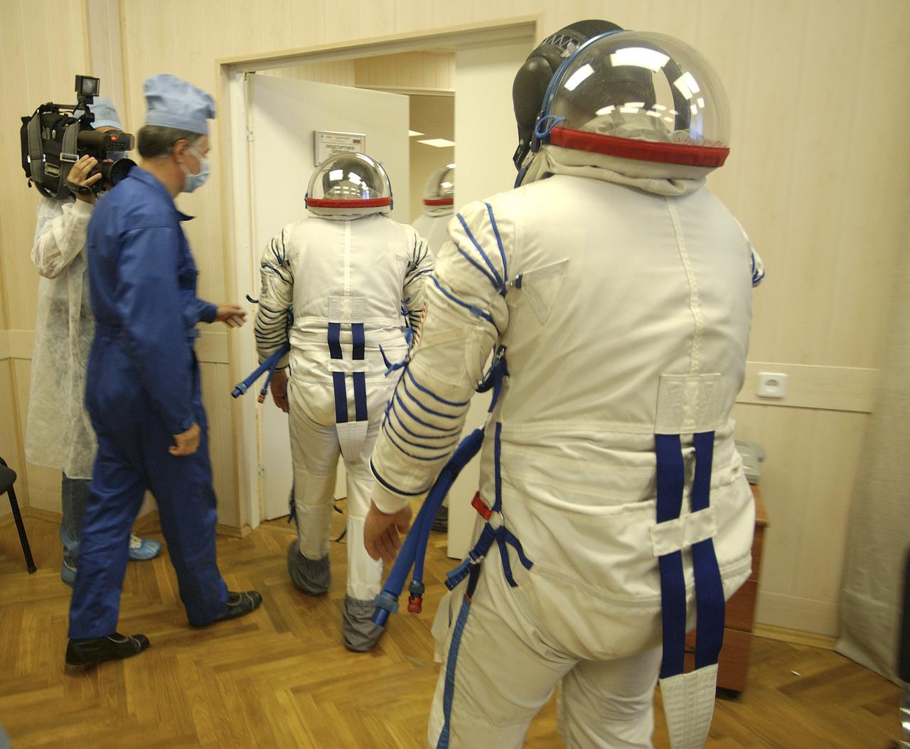Expedition 10 Commander and NASA Science Officer Leroy Chiao, Flight Engineer and Soyuz Commander Salizhan Sharipov and Russian Space Forces cosmonaut Yuri Shargin donned their launch and entry suits and climbed aboard their Soyuz TMA-5 spacecraft Friday, October 5, 2004, at the Baikonur Cosmodrome in Kazakhstan for a dress rehearsal of launch day activities leading to their liftoff October 14 to the International Space Station.  Chiao and Sharipov, the first crew of all-Asian extraction, will spend six months on the Station.  Shargin will return to Earth October 24 with the Stations' current residents, Expedition 9 Commander Gennady Padalka and NASA Flight Engineer and Science Officer Mike Fincke.  Photo Credit: (NASA/Bill Ingalls)