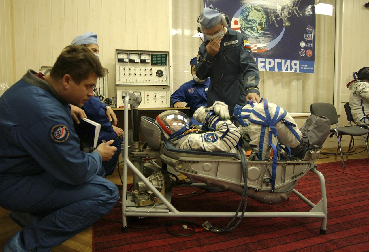 Russian Space Forces cosmonaut Yuri Shargin donned his launch and entry suit and climbed aboard the Soyuz TMA-5 spacecraft Friday, October 5, 2004, at the Baikonur Cosmodrome in Kazakhstan for a dress rehearsal of launch day activities leading to their liftoff October 14 to the International Space Station.  Chiao and Sharipov, the first crew of all-Asian extraction, will spend six months on the Station.  Shargin will return to Earth October 24 with the Stations' current residents, Expedition 9 Commander Gennady Padalka and NASA Flight Engineer and Science Officer Mike Fincke.  Photo Credit: (NASA/Bill Ingalls) 