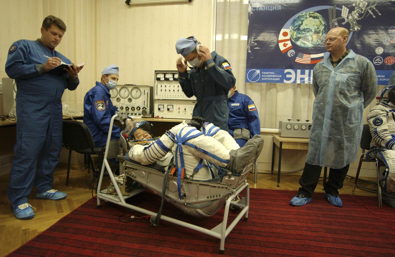 Expedition 10 Commander and NASA Science Officer Leroy Chiao, right, Flight Engineer and Soyuz Commander Salizhan Sharipov donned their launch and entry suits and climbed aboard their Soyuz TMA-5 spacecraft Friday, October 5, 2004, at the Baikonur Cosmodrome in Kazakhstan for a dress rehearsal of launch day activities leading to their liftoff October 14 to the International Space Station.  Chiao and Sharipov, the first crew of all-Asian extraction, will spend six months on the Station.  Shargin will return to Earth October 24 with the Stations' current residents, Expedition 9 Commander Gennady Padalka and NASA Flight Engineer and Science Officer Mike Fincke.  Photo Credit: (NASA/Bill Ingalls) 