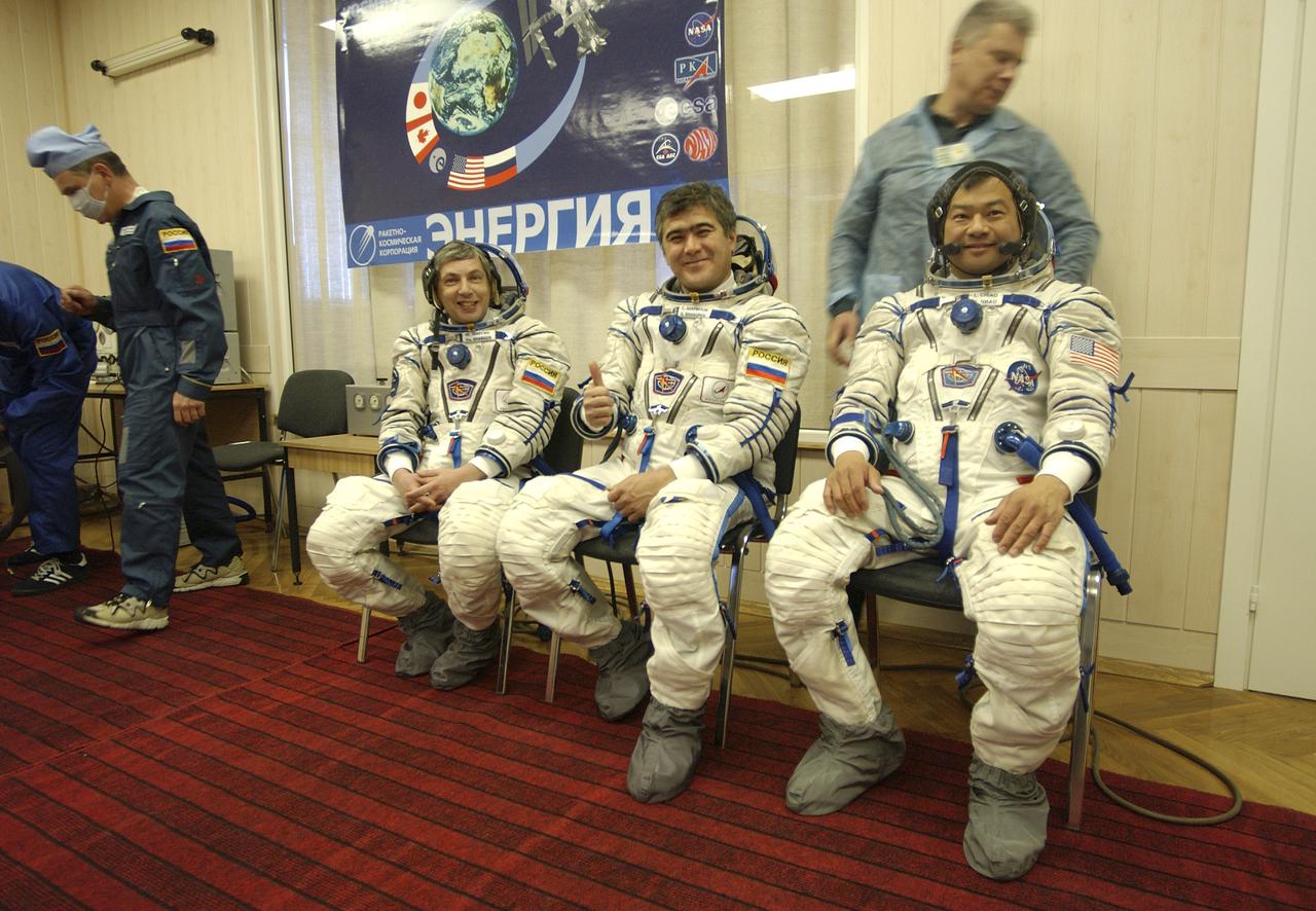 Expedition 10 Commander and NASA Science Officer Leroy Chiao, right, Flight Engineer and Soyuz Commander Salizhan Sharipov and Russian Space Forces cosmonaut Yuri Shargin, left, donned their launch and entry suits and climbed aboard their Soyuz TMA-5 spacecraft Friday, October 5, 2004, at the Baikonur Cosmodrome in Kazakhstan for a dress rehearsal of launch day activities leading to their liftoff October 14 to the International Space Station. Chiao and Sharipov, the first crew of all-Asian extraction, will spend six months on the Station.  Shargin will return to Earth October 24 with the Stations' current residents, Expedition 9 Commander Gennady Padalka and NASA Flight Engineer and Science Officer Mike Fincke.  Photo Credit: (NASA/Bill Ingalls) 