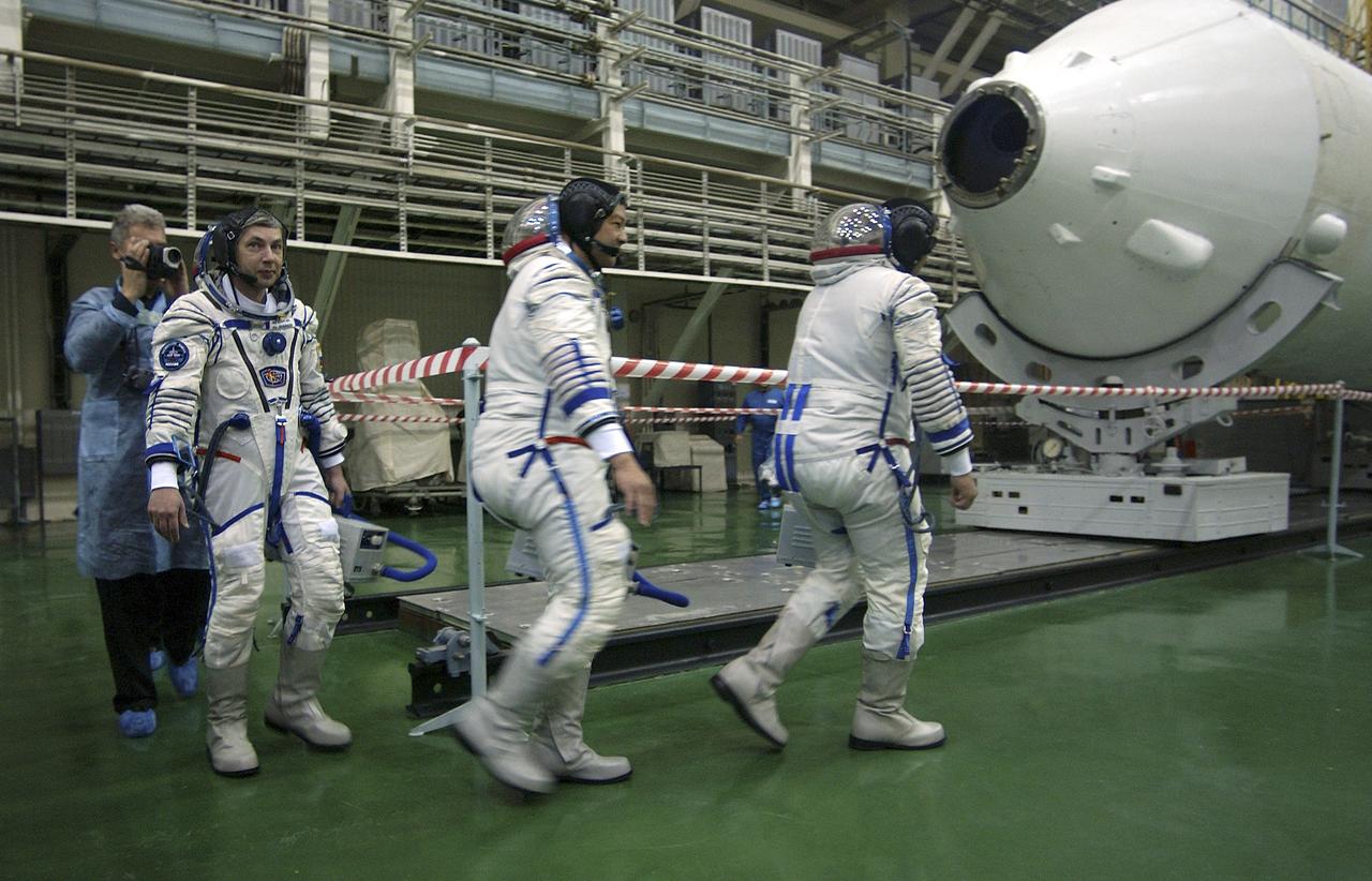 Expedition 10 Flight Engineer and Soyuz Commander Salizhan Sharipov, right, Expedition 10 Commander and NASA Science Officer Leroy Chiao, Russian Space Forces cosmonaut Yuri Shargin, left, donned their launch and entry suits and climbed aboard their Soyuz TMA-5 spacecraft Friday, October 5, 2004, at the Baikonur Cosmodrome in Kazakhstan for a dress rehearsal of launch day activities leading to their liftoff October 14 to the International Space Station.  Chiao and Sharipov, the first crew of all-Asian extraction, will spend six months on the Station.  Shargin will return to Earth October 24 with the Stations' current residents, Expedition 9 Commander Gennady Padalka and NASA Flight Engineer and Science Officer Mike Fincke.  Photo Credit: (NASA/Bill Ingalls)