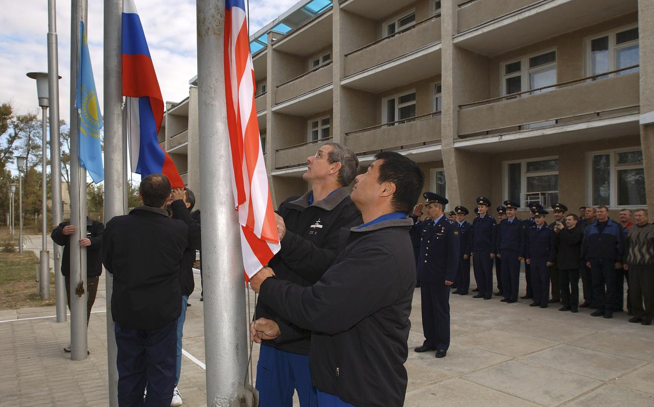 Expedition 10 Flight Engineer and Soyuz Commander Salizhan Sharipov, Commander and NASA Science Officer Leroy Chiao, Russian Space Forces Cosmonaut Yuri Shargin, backup Soyuz Commander Valery Tokarev and backup Expedition Commander Bill McArthur patricipate in the ceremonial flag raising at the Cosmonaut Hotel, Baikonur, Kazakhstan, Wednesday, Oct. 6, 2004. Chiao, Sharipov and Shargin are scheduled to launch October 14 on their Soyuz TMA-5 spacecraft to the International Space Station. Photo Credit: (NASA/Bill Ingalls)