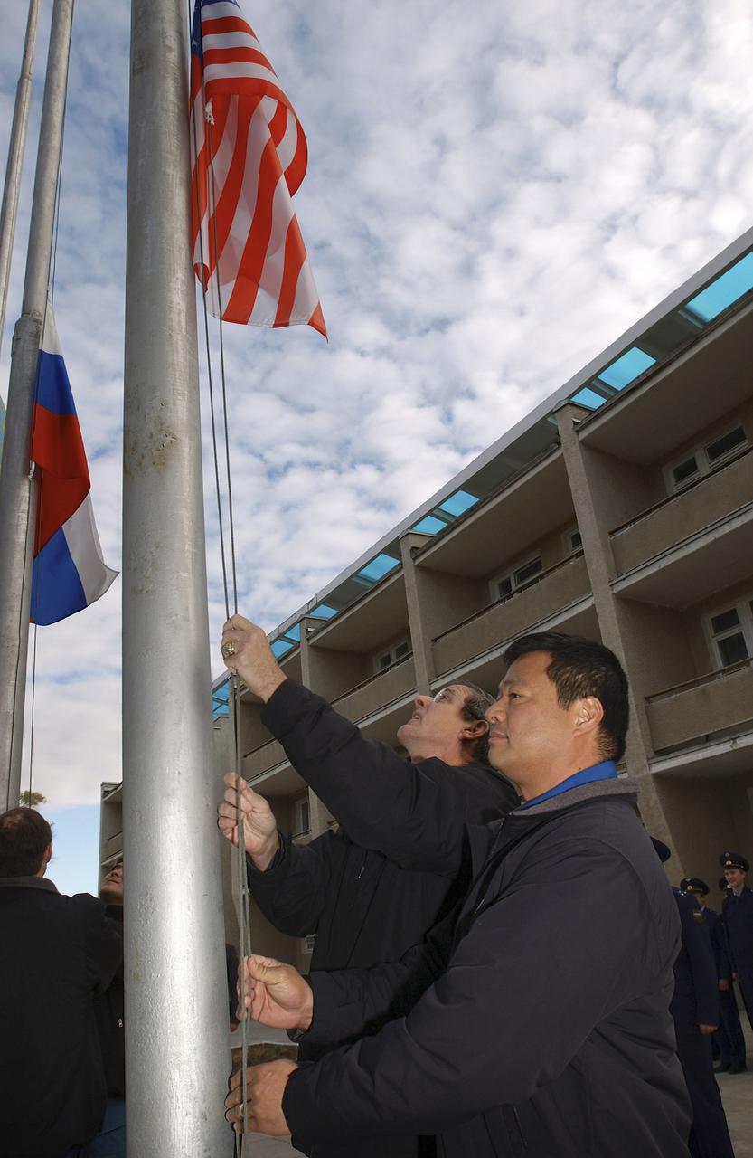 Expedition 10 Commander and NASA Science Officer Leroy Chiao, right, and backup Expedition 10 Commander Bill McArthur patricipate in the ceremonial flag raising at the Cosmonaut Hotel, Baikonur, Kazakhstan, Wednesday, Oct. 6, 2004. Chiao, Sharipov and Shargin are scheduled to launch October 14 on their Soyuz TMA-5 spacecraft to the International Space Station. Photo Credit: (NASA/Bill Ingalls)