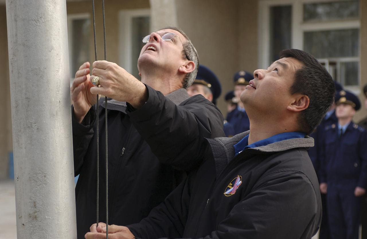 Expedition 10 Commander and NASA Science Officer Leroy Chiao, right, and backup Expedition 10 Commander Bill McArthur patricipate in the ceremonial flag raising at the Cosmonaut Hotel, Baikonur, Kazakhstan, Wednesday, Oct. 6, 2004. Chiao, Sharipov and Shargin are scheduled to launch October 14 on their Soyuz TMA-5 spacecraft to the International Space Station. Photo Credit: (NASA/Bill Ingalls)