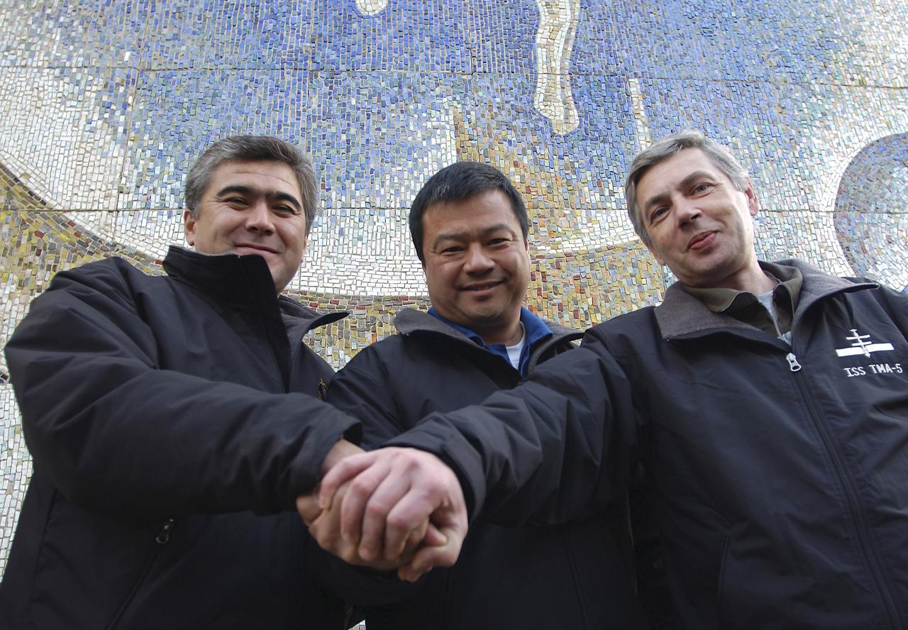 Expedition 10 Flight Engineer and Soyuz Commander Salizhan Sharipov, left, Commander and NASA Science Officer Leroy Chiao and Russian Space Forces cosmonaut Yuri Shargin, right, pose for a photo after they patricipated in the ceremonial flag raising at the Cosmonaut Hotel, Baikonur, Kazakhstan, Wednesday, Oct. 6, 2004. Chiao, Sharipov and Shargin are scheduled to launch October 14 on their Soyuz TMA-5 spacecraft to the International Space Station. Photo Credit: (NASA/Bill Ingalls)