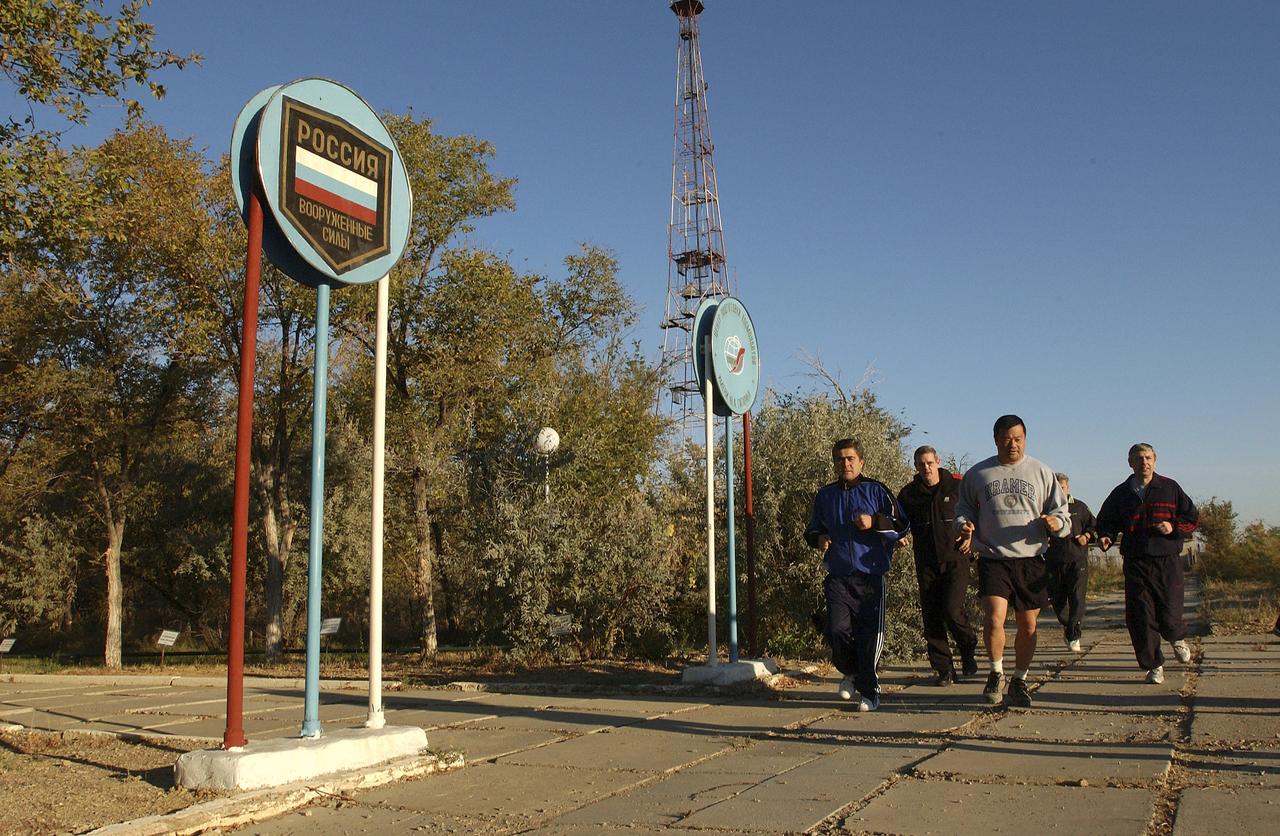 Expedition 10 Flight Engineer and Soyuz Commander Salizhan Sharipov foreground left, Commander and NASA Science Officer Leroy Chiao, Russian Space Forces cosmonaut Yuri Shargin, backup Soyuz Commander Valery Tokarev and backup Expedition Commander Bill McArthur, background left, go for an early morning jog on the grounds of the Cosmonaut Hotel, Baikonur, Kazakhstan, Friday, October 8, 2004. Chiao, Sharipov and Shargin are scheduled to launch October 14 on their Soyuz TMA-5 spacecraft to the International Space Station. Photo Credit: (NASA/Bill Ingalls)