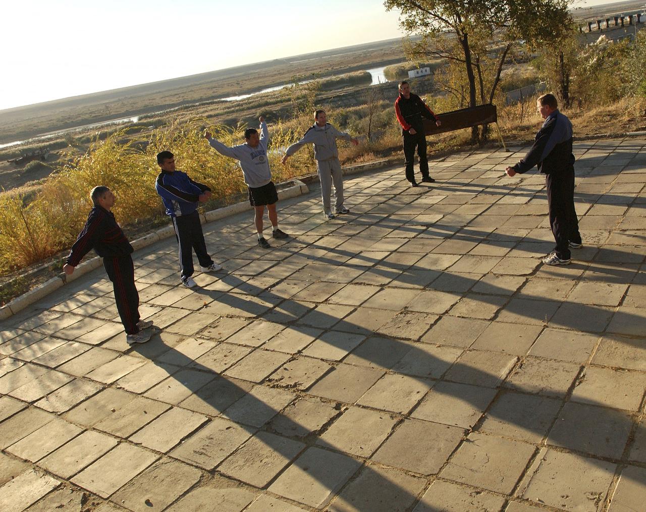 From left to right, Russian Space Forces cosmonaut Yuri Shargin, Expedition 10 Flight Engineer and Soyuz Commander Salizhan Sharipov, Commander and NASA Science Officer Leroy Chiao, backup Soyuz Commander Valery Tokarev and backup Expedition Commander Bill McArthur are lead by an instructor for early morning exercises on the grounds of the Cosmonaut Hotel, Baikonur, Kazakhstan, Friday, October 8, 2004. Chiao, Sharipov and Shargin are scheduled to launch October 14 on their Soyuz TMA-5 spacecraft to the International Space Station. Photo Credit: (NASA/Bill Ingalls)