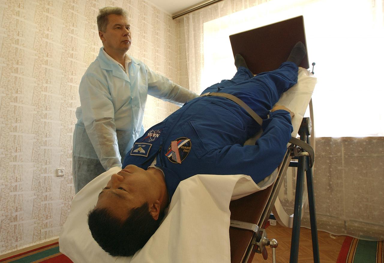 Expedition 10 Commander Leroy Chiao undergoes physical testing on a mechanized tilt table at crew quarters in Baikonur, Kazakhstan, Friday, October 8, 2004, in preparation for launch with Flight Engineer and Soyuz Commander Salizhan Sharipov and Russian Space Forces Agency cosmonaut Yuri Shargin to the International Space Station on October 14. The tilt table is used to condition the crewmembers' cardiovascular system against the effects of weightlessness once on orbit.  Photo Credit: (NASA/Bill Ingalls)