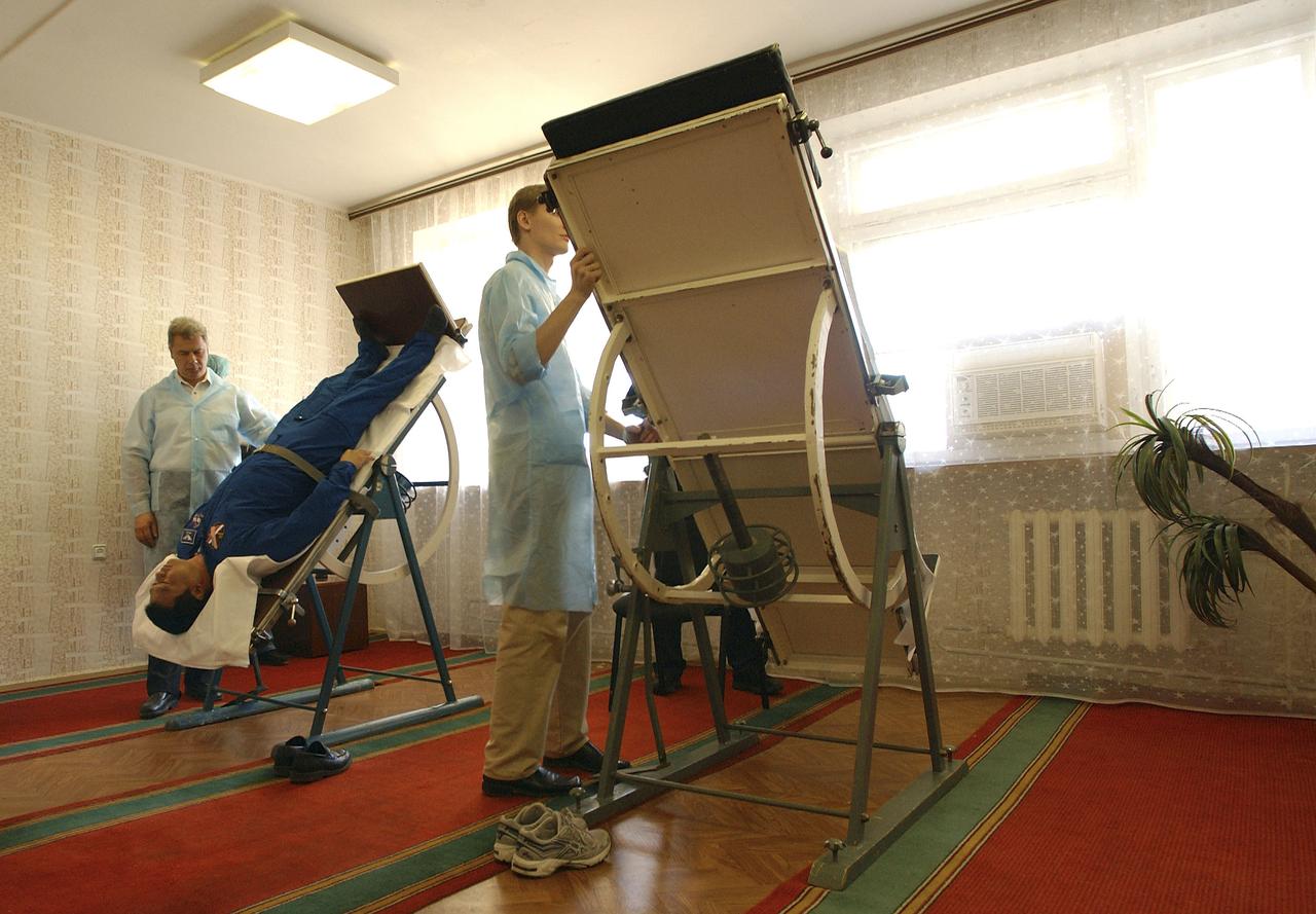 Expedition 10 Commander Leroy Chiao undergoes physical testing on a mechanized tilt table at crew quarters in Baikonur, Kazakhstan, Friday, October 8, 2004, in preparation for launch with Flight Engineer and Soyuz Commander Salizhan Sharipov and Russian Space Forces Agency cosmonaut Yuri Shargin to the International Space Station on October 14. The tilt table is used to condition the crewmembers' cardiovascular system against the effects of weightlessness once on orbit.  Photo Credit: (NASA/Bill Ingalls)