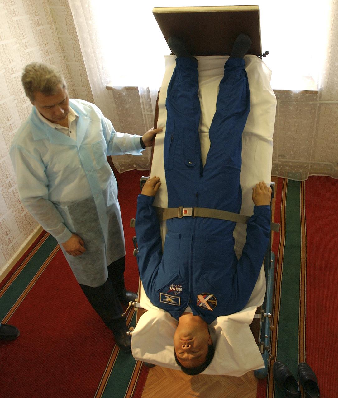 Expedition 10 Commander Leroy Chiao undergoes physical testing on a mechanized tilt table at crew quarters in Baikonur, Kazakhstan, Friday, October 8, 2004, in preparation for launch with Flight Engineer and Soyuz Commander Salizhan Sharipov and Russian Space Forces Agency cosmonaut Yuri Shargin to the International Space Station on October 14. The tilt table is used to condition the crewmembers' cardiovascular system against the effects of weightlessness once on orbit.  Photo Credit: (NASA/Bill Ingalls)