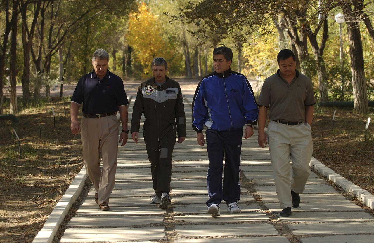Expedition 10 Commander Leroy Chiao, right, Flight Engineer and Soyuz Commander Salizhan Sharipov, Russian Space Forces Cosmonaut Yuri Shargin, and the lead Russian Flight Surgeon, left, enjoy a middday stroll down the Walkway of Cosmonauts at their crew quarters in Baikonur, Kazakhstan, Friday, October 8, 2004 as they prepare for liftoff to the International Space Station October 14. Photo Credit: (NASA/Bill Ingalls)