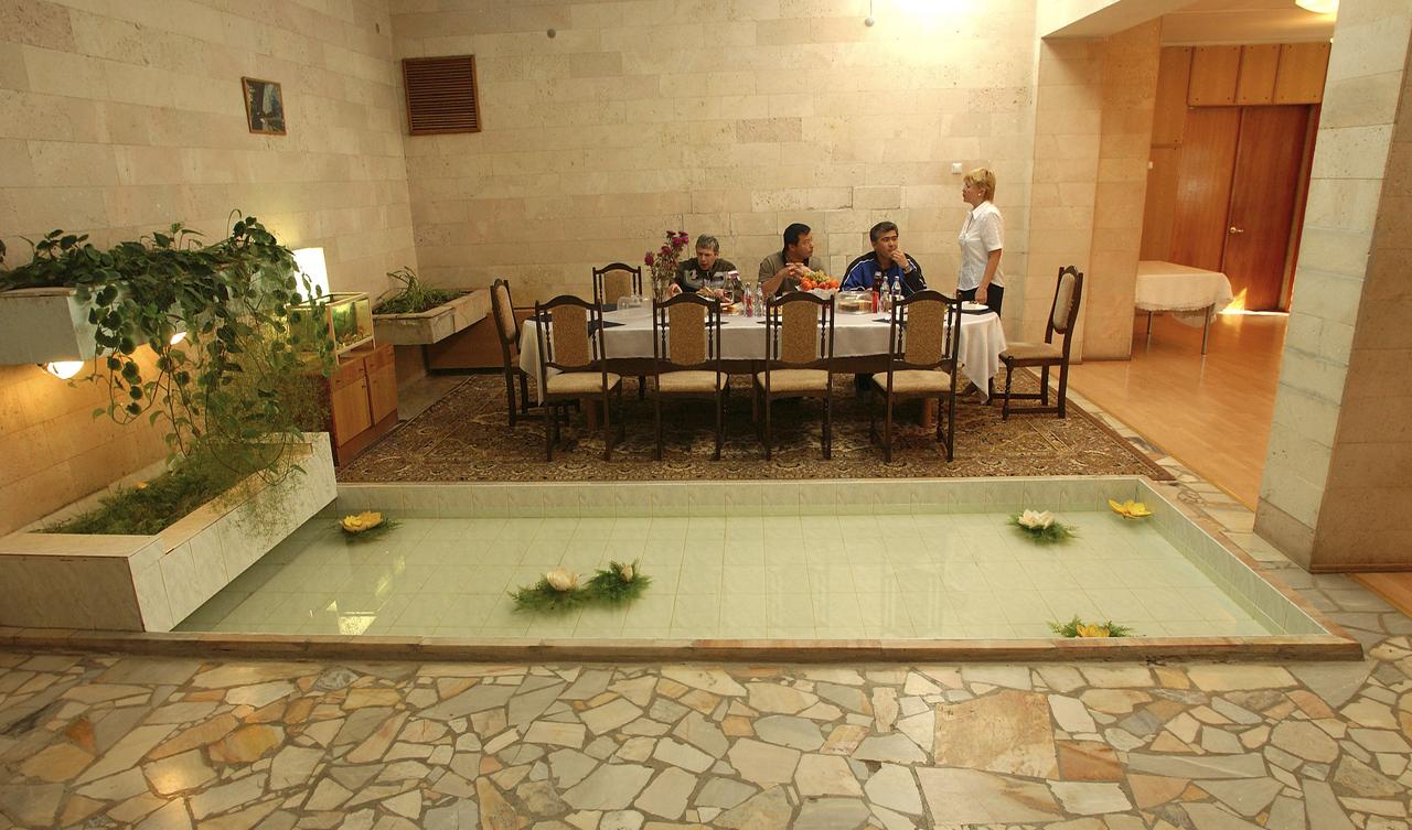 Expedition 10 Commander Leroy Chiao, right, Flight Engineer and Soyuz Commander Salizhan Sharipov and Russian Space Forces cosmonaut Yuri Shargin, left, enjoy lunch at their crew quarters in Baikonur, Kazakhstan, Friday, October 8, 2004, as they prepare for liftoff to the International Space Station October 14.  Photo Credit: (NASA/Bill Ingalls)