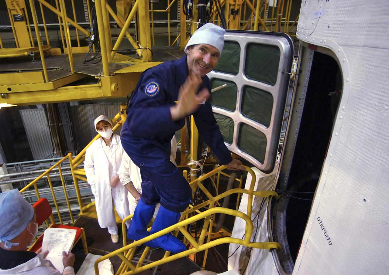 Expedition 10 backup Soyuz Commander Valery Tokarev enters the Soyuz capsule for a final check Saturday, Oct. 9, 2004, at the Baikonur Cosmodrome in Kazakhstan. Expedition 10 is scheduled to launch October 14 on the Soyuz TMA-5 spacecraft to the International Space Station. Photo Credit: (NASA/Bill Ingalls)