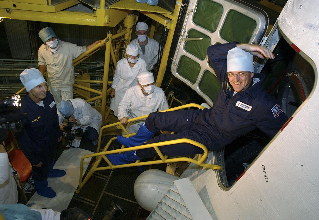 Expedition 10 backup Soyuz Commander Valery Tokarev, left, watches backup Expedition 10 Commander Bill McArthur exit the Soyuz capsule after their final check of the spacecraft Saturday, October 9, 2004 at the Baikonur Cosmodrome in Kazakhstan. Expedition 10 is scheduled to launch October 14 on the Soyuz TMA-5 spacecraft to the International Space Station. Photo Credit: (NASA/Bill Ingalls)