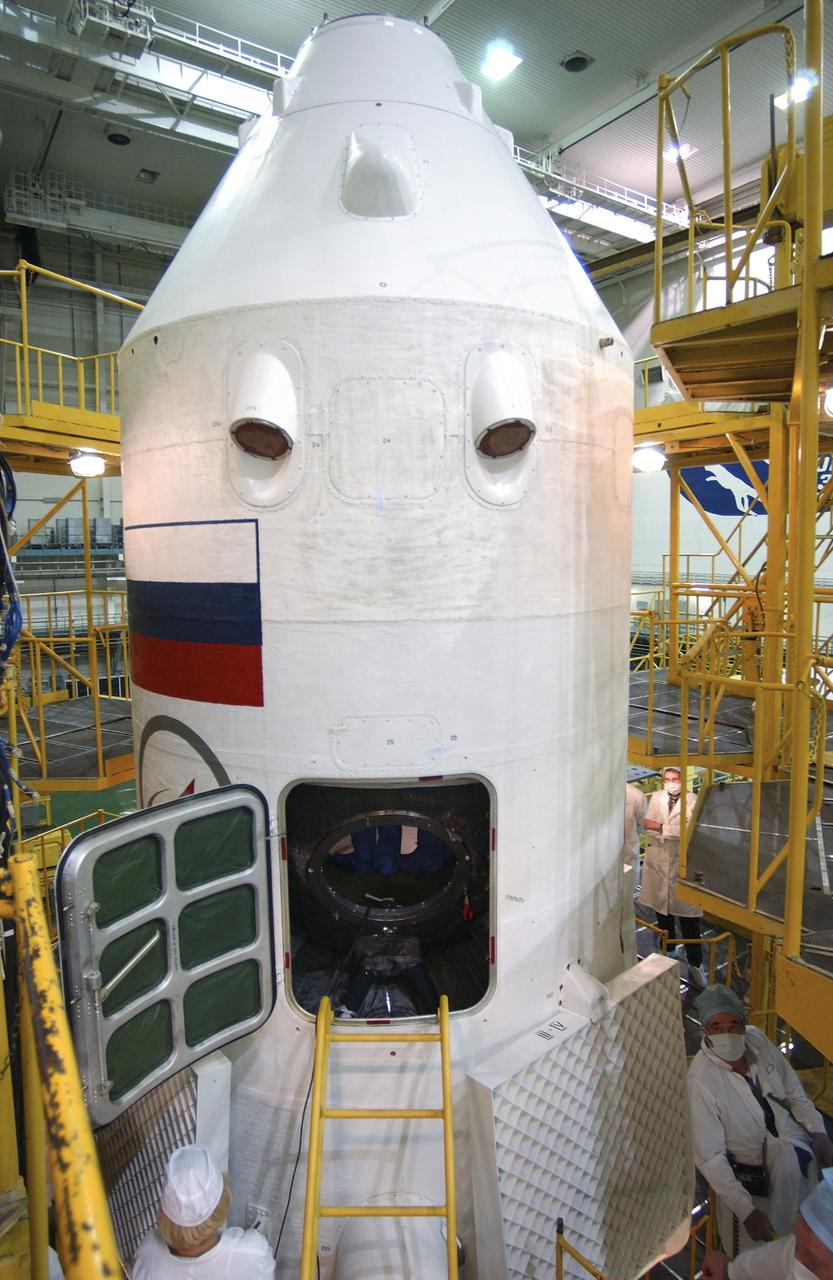 Expedition 10 Commander and NASA Science Officer Leroy Chiao, Flight Engineer and Soyuz Commander Salizhan Sharipov and Russian Space Forces Cosmonaut Yuri Shargin conducted a final inspection of their Soyuz TMA-5 spacecraft Saturday, October 9, 2004 at the Baikonur Cosmodrome in Kazakhstan in preparation for their launch October 14 to the International Space Station.  The Soyuz vehicle will be mated to its booster rocket October 11 in preparation for its rollout to the Central Asian launch pad October 12. Photo Credit: (NASA/Bill Ingalls)