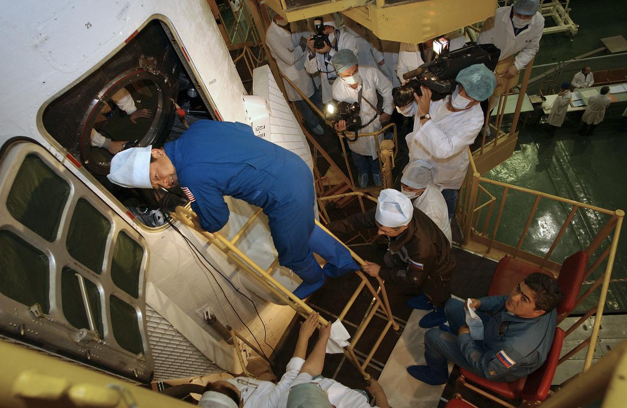 Expedition 10 Commander and NASA Science Officer Leroy Chiao, left, Russian Space Forces cosmonaut Yuri Shargin and Flight Engineer and Soyuz Commander Salizhan Sharipov, lower right, conducted a final inspection of their Soyuz TMA-5 spacecraft on Saturday, October 9, 2004, at the Baikonur Cosmodrome in Kazakhstan in preparation for their launch October 14 to the International Space Station.  The Soyuz vehicle will be mated to its booster rocket October 11 in preparation for its rollout to the Central Asian launch pad October 12.  Photo Credit: (NASA/Bill Ingalls) 