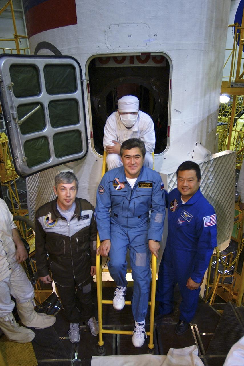 Expedition 10 Commander and NASA Science Officer Leroy Chiao, right, Flight Engineer and Soyuz Commander Salizhan Sharipov and Russian Space Forces cosmonaut Yuri Shargin, left, conducted a final inspection of their Soyuz TMA-5 spacecraft on Saturday, October 9, 2004, at the Baikonur Cosmodrome in Kazakhstan in preparation for their launch October 14 to the International Space Station.  The Soyuz vehicle will be mated to its booster rocket October 11 in preparation for its rollout to the Central Asian launch pad October 12.  Photo Credit: (NASA/Bill Ingalls)