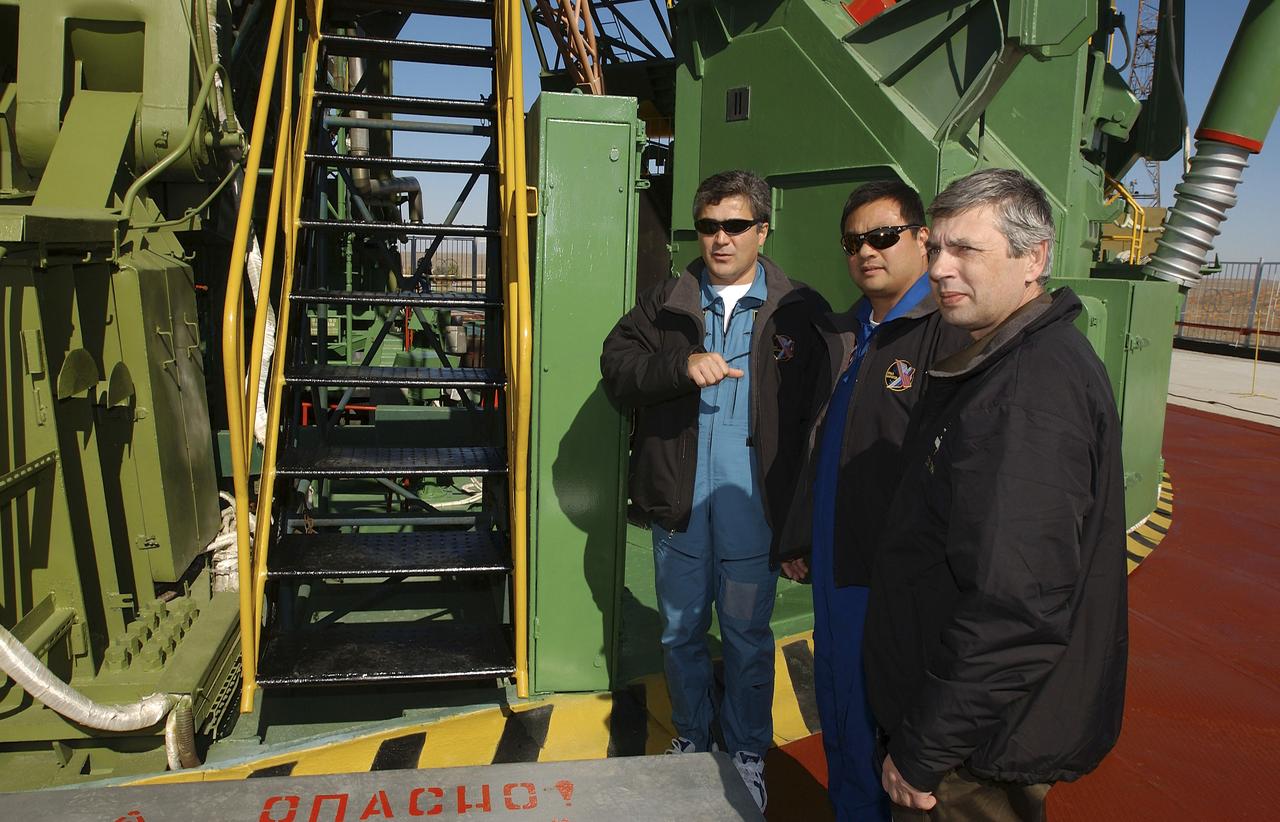 Flight Engineer and Soyuz Commander Salizhan Sharipov, left, Expedition 10 Commander and NASA Science Officer Leroy Chiao and Russian Space Forces cosmonaut Yuri Shargin, right, toured their launch pad on Saturday, October 9, 2004, at the Baikonur Cosmodrome in Kazakhstan prior to their liftoff to the International Space Station October 14.  Their Soyuz rocket will roll out to the pad on October 12.  Photo Credit: (NASA/Bill Ingalls)